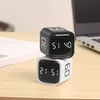 Two cube timers stacked on a wooden desk, with a laptop in the background. Produktbild-Vorschau
