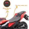 Close-up view of a red electric toy motorcycle, highlighting its features with text and arrows. Náhľad obrázku produktu