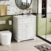 A modern bathroom with a white vanity, toilet, and shower. Podgląd zdjęcia produktu