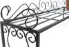 A close-up view of a black metal plant stand with decorative scrollwork. Anteprima dell’immagine prodotto