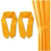 Two orange curtain tie-backs are shown against a white background, with a section of orange curtain visible on the right side. Produktbild-Vorschau