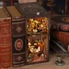 A detailed 3D model of a miniature library or study, designed to be placed between books on a shelf, is shown. It is surrounded by several large, old-looking books. Voir les images du produit