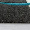 A close-up view of a carpet with a geometric pattern. Anteprima dell’immagine prodotto