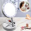 A makeup mirror with LED lights and a tray for cosmetics, shown on a marble countertop with lipstick and scattered makeup. Náhľad obrázku produktu