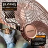 A woman relaxing on a couch with a laptop, with a large copper fan in the background. Podgląd zdjęcia produktu