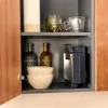 A kitchen cabinet with various items on shelves. Anteprima dell’immagine prodotto