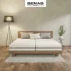 A bedroom scene with a bed, lamp, and plant. Náhľad obrázku produktu