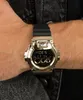 A person wearing a gold Casio G-Shock watch on their wrist. Podgląd zdjęcia produktu