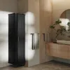A modern bathroom with a tall black cabinet, a wooden vanity with a stone sink, and a round mirror. Produktbild-Vorschau