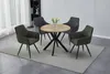 A round dining table with four chairs on a rug in a room. Produktbild-Vorschau