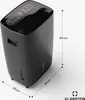A black dehumidifier is shown on a light gray background with dimensions indicated by lines and text. Náhľad obrázku produktu