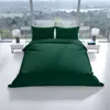 A dark green duvet set is laid out on a bed in front of a large window with a scenic view. Produktbild-Vorschau