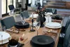 A beautifully set dining table with dark plates, glassware, and cutlery, suggesting a formal dinner setting. Produktbild-Vorschau