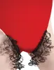A close-up of a red garment with attached black curly hair, simulating pubic hair. Produktbild-Vorschau
