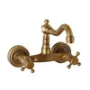 A vintage-style brass wall-mounted faucet against a white background. Podgląd zdjęcia produktu