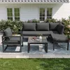 A modern outdoor furniture set arranged on a patio with a house and garden in the background. Anteprima dell’immagine prodotto