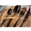 Cutlery set arranged on a wooden slice with a wheat stalk. Náhled obrázku produktu