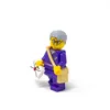 A Lego minifigure of a postman holding a letter and wearing a satchel. Produktbild-Vorschau