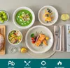 A table setting with various dishes and tableware, including soup, salad, fish, and dessert. Produktbild-Vorschau