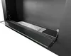 A close-up view of a modern black ethanol fireplace with a glass shelf. Voir les images du produit