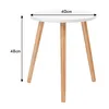 A white round table with three wooden legs, shown from a diagonal angle. Dimensions are indicated by arrows and text. Produktbild-Vorschau