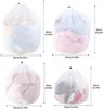 A collage of four different sizes of white mesh laundry bags filled with clothes, with dimensions indicated. Produktbild-Vorschau