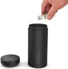 A hand is shown adding liquid from a small bottle into a black aroma diffuser. Náhľad obrázku produktu