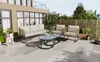 An outdoor patio set with a sofa, two chairs, and a coffee table, set on a tiled patio with plants and a fence in the background. Náhľad obrázku produktu