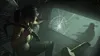 A woman in tactical gear is looking through a broken window, holding a weapon. Produktbild-Vorschau