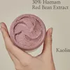 A hand holding a jar of pink skincare product with visible exfoliating particles. Produktbild-Vorschau