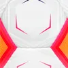 A close-up, symmetrical view of a white soccer ball with geometric patterns and colorful accents. Produktbild-Vorschau