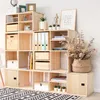A modular wooden bookshelf filled with various items, including books, binders, decorative objects, and storage boxes, set against a white brick wall. Anteprima dell’immagine prodotto