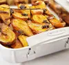 A close-up view of baked pears in a roasting pan, garnished with spices and orange zest. Produktbild-Vorschau
