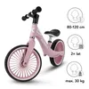 A pink balance bike with informational graphics on the right side. Náhľad obrázku produktu