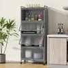 A gray kitchen cabinet with multiple shelves and transparent doors, standing next to a potted plant and a kitchen counter. Náhled obrázku produktu