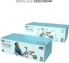 Two boxes of Kinderkraft CUTIE mini balance bikes are shown, one in the foreground and one in the background. The box in the foreground features an image of a child sitting next to the bike. Voir les images du produit