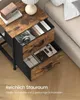 A bedside table with open drawers, showing items inside, next to a bed. Produktbild-Vorschau
