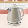 A vintage-style electric kettle is placed on a table in a kitchen setting. Anteprima dell’immagine prodotto