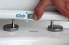 A hand is shown adjusting a toilet seat hinge mechanism. Produktbild-Vorschau