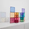 A collection of colorful magnetic tiles stacked in a playful structure on a white surface. Podgląd zdjęcia produktu