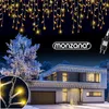 A modern house decorated with icicle lights for Christmas. Anteprima dell’immagine prodotto