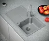 A granite kitchen sink with a faucet and a bowl of apples on a speckled countertop. Produktbild-Vorschau