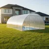 A covered swimming pool in a backyard with a modern house in the background. Produktbild-Vorschau
