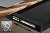 A sliding drawer attached under a desk, with a laptop partially visible on the desk surface. An icon indicating quiet operation is in the lower-left corner. Podgląd zdjęcia produktu