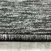 A close-up, side view of a carpet with a textured, striped pattern. Produktbild-Vorschau