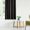 A dark curtain hangs in front of a window, with a small white table and a green chair in the foreground. Produktbild-Vorschau