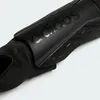 A close-up view of a black Adidas shin guard. Produktbild-Vorschau