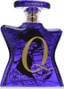 A close-up studio shot of a blue glass perfume bottle with a gold 'Q' and a world map design. Voir les images du produit