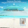 A striped beach umbrella on a sandy beach with the ocean in the background. Náhled obrázku produktu