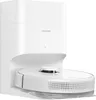 A white robot vacuum cleaner docked in its charging/emptying station. Voir les images du produit